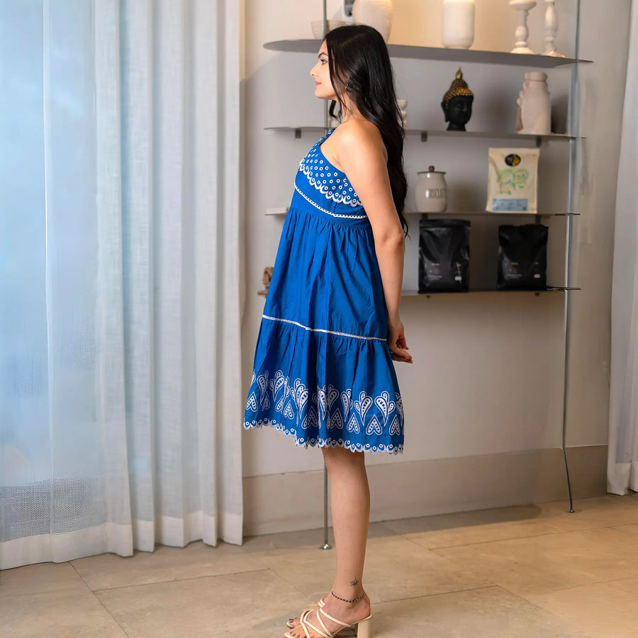 Side profile view highlighting the airy fit of a short western dress with embroidered detailing