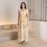 Front pose showing a floral A-line maxi styled for festive occasions and brunch outings.