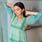 Close-up of aqua chiffon one piece dress for women with floral details, suited for festivals.