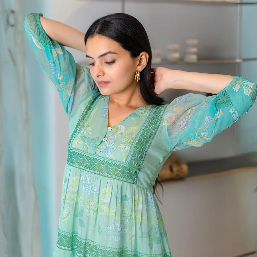 Close-up of aqua chiffon one piece dress for women with floral details, suited for festivals.