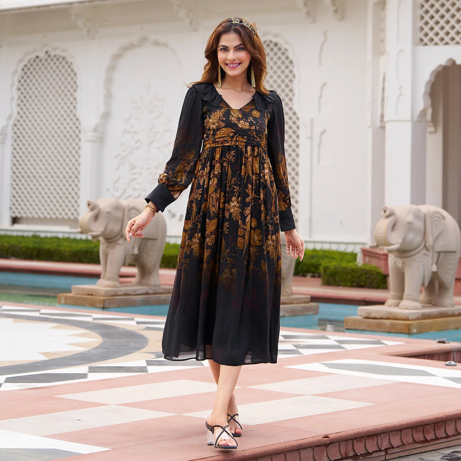 Woman in a black floral midi dress walking confidently in a palace courtyard
