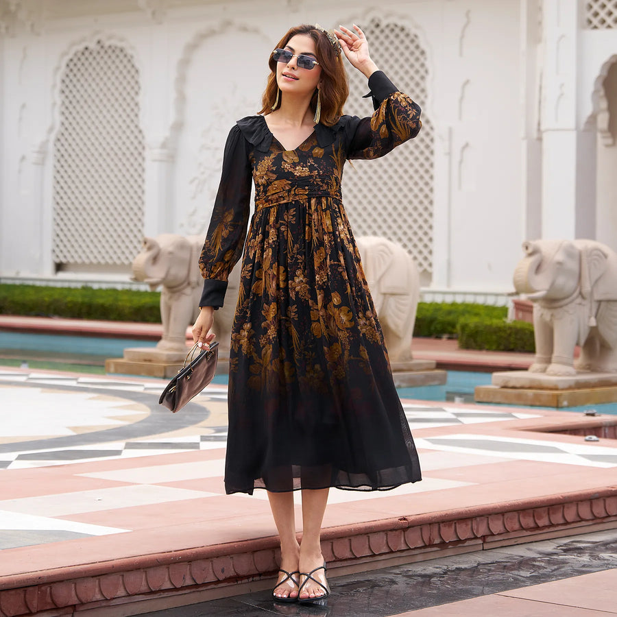 Woman wearing black one piece dress with floral print, holding purse