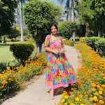 Smiling influencer in designer cotton dress for women with vivid cactus print.