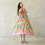Designer dress for women twirling gracefully with pink cactus motifs.