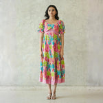 Cotton maxi dress for women with bright pink and green cactus print, front view.