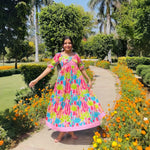 Influencer twirling outdoors in maxi dress for women featuring blush cactus print.