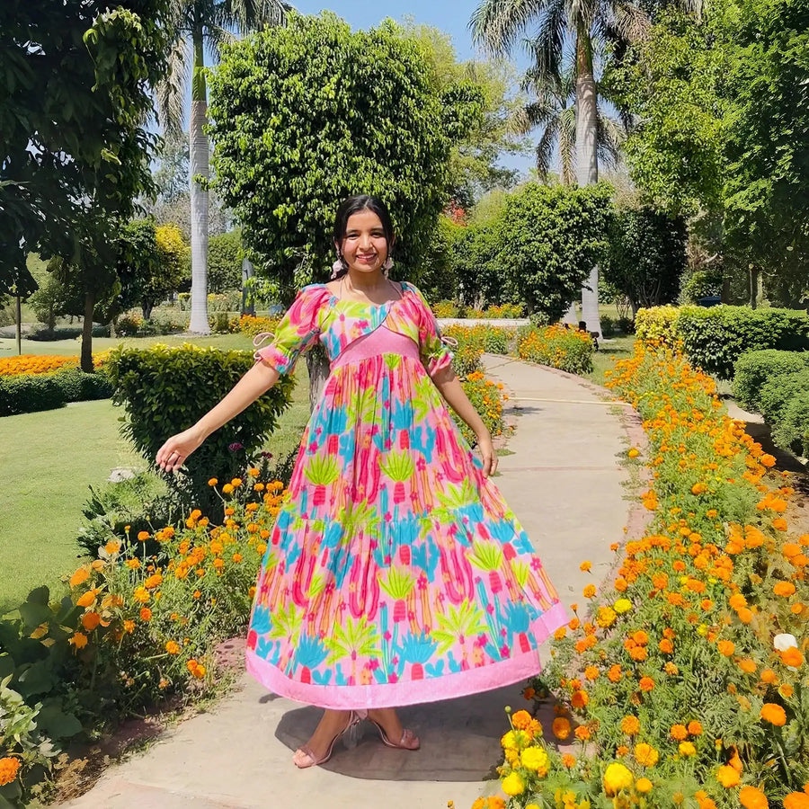 Influencer twirling outdoors in maxi dress for women featuring blush cactus print.