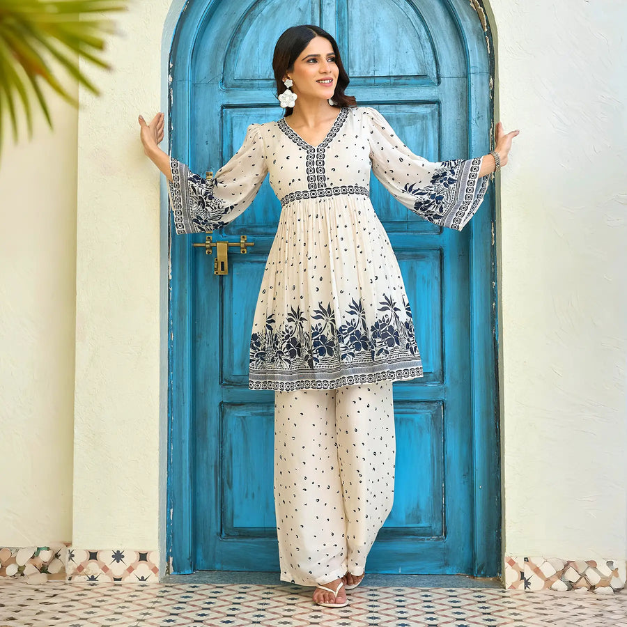 Playful extended arm pose highlighting the printed co ord set for women with navy floral borders.