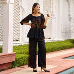 Cheerful pose in floral co ord set, black base with autumn-inspired prints, designed for festive co ord set vibes and holiday wear.