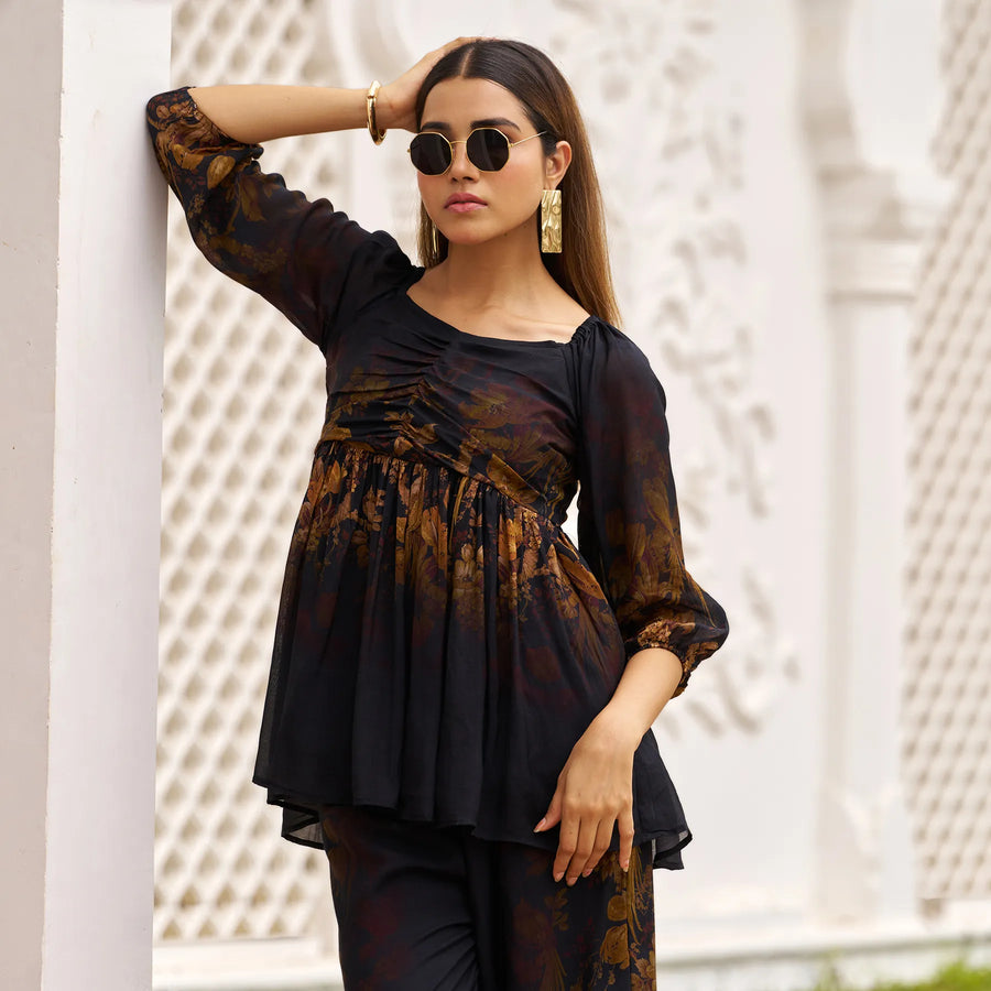 Close-up of women’s co ord set with detailed autumn floral print and ruched top.