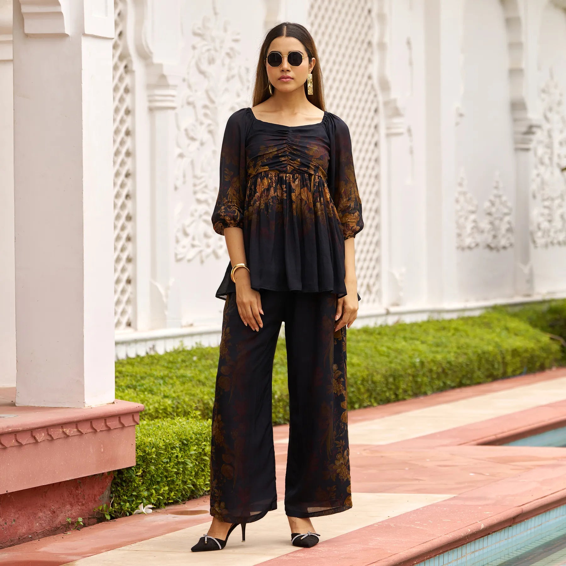 Woman wearing Autumn Bloom floral co ord set, featuring a flowy top with puffed sleeves and wide-leg pants, perfect for casual outings and brunch dates.