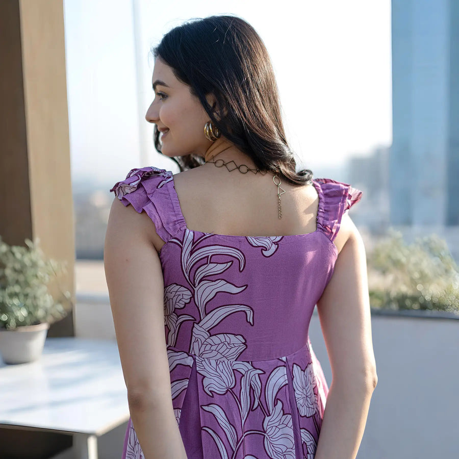 Back view of purple floral maxi dress with cute shoulder details, great for holiday outings.