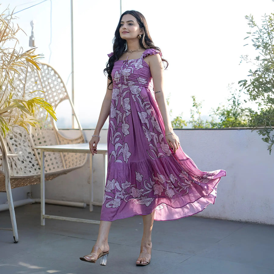 Walking shot of woman wearing a purple floral maxi dress, ideal for holidays.