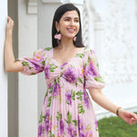 Smiling woman in a floral midi dress – a charming sundress for summer or beach days.
