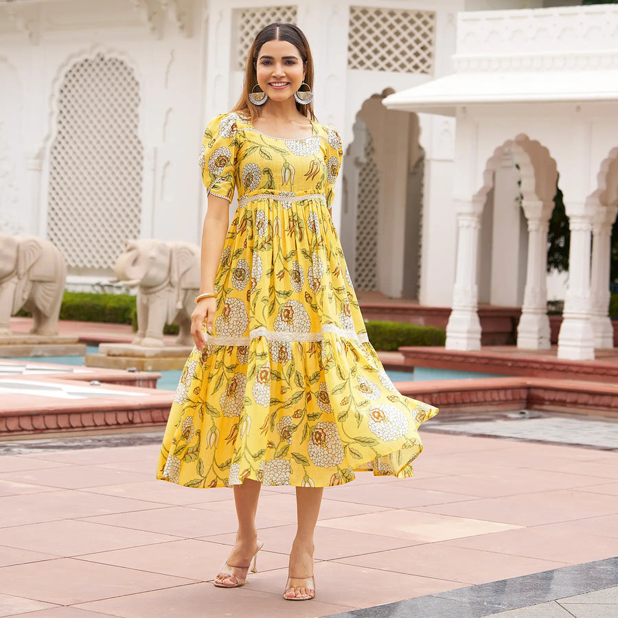 Twirling shot of floral summer midi dresses – Marigold Aura style in yellow, great for festive mornings.