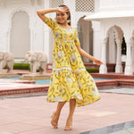 Yellow midi dresses for women – dancing pose with floral print, perfect as a sundress or Haldi ceremony outfit