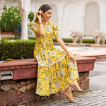 Sitting pose of Yellow sundress – relaxed floral design perfect for vacation or Haldi function.