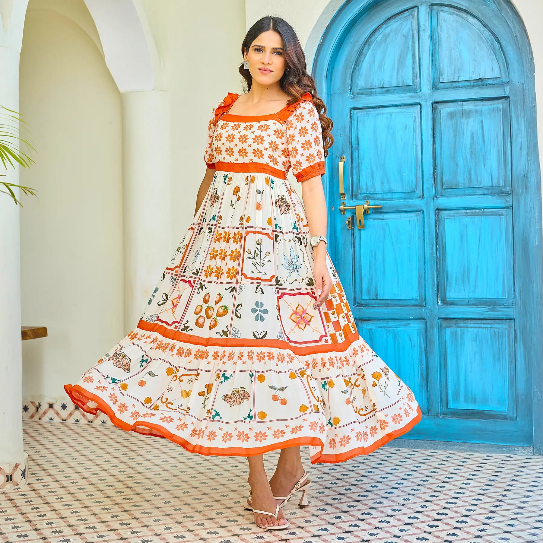 Woman twirling in printed white maxi dress — light, airy, and movement-friendly.