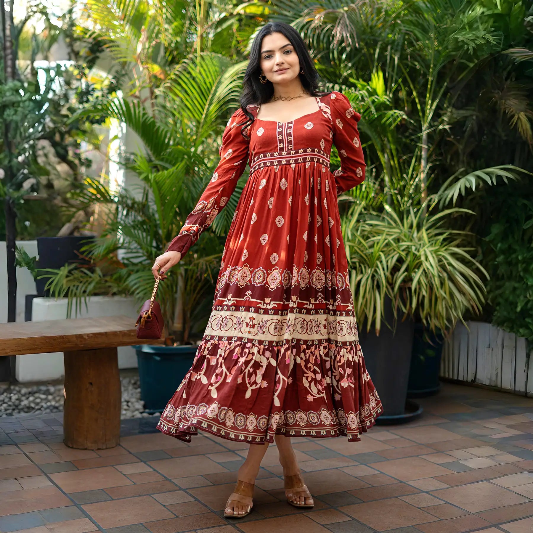 Front standing pose in a maroon long sleeve dress, styled with a handbag — perfect for festive dinners and cultural events.