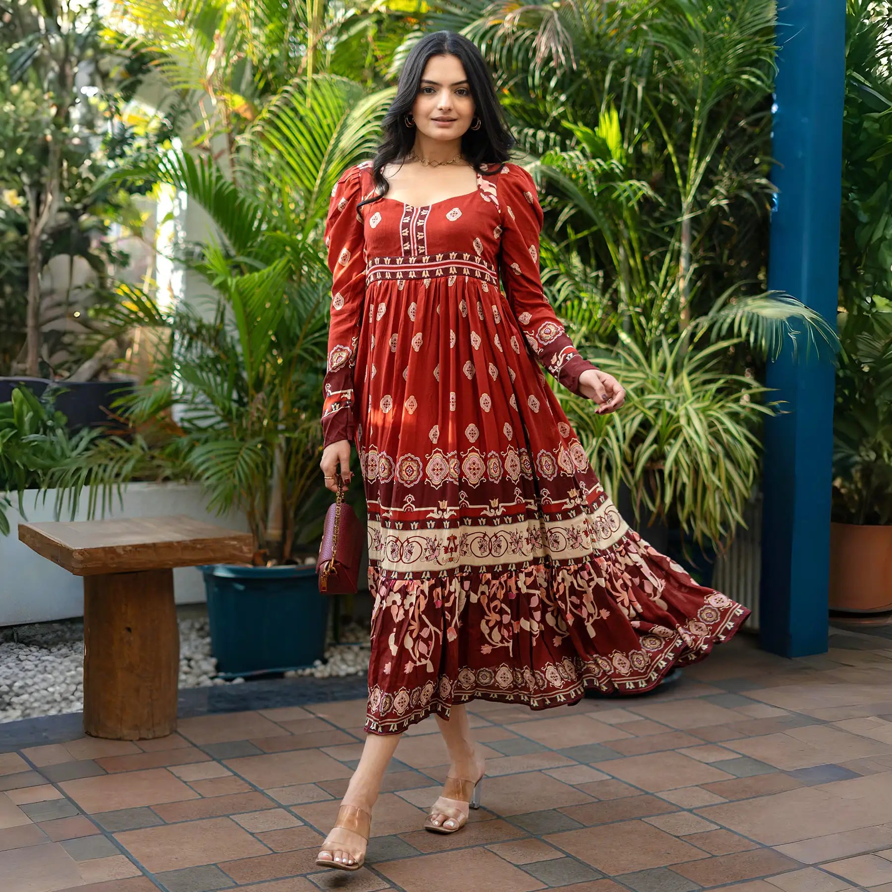 Movement shot of a maroon long sleeve maxi dress with flared hemline — stylish for festivals and traditional celebrations.
