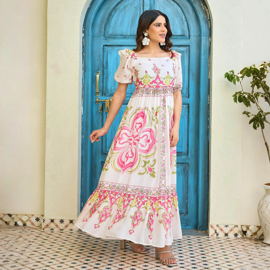 Elegant long maxi dress with pink floral motif print and puffed sleeves, shown from a side angle, perfect for brunch or birthday occasions.
