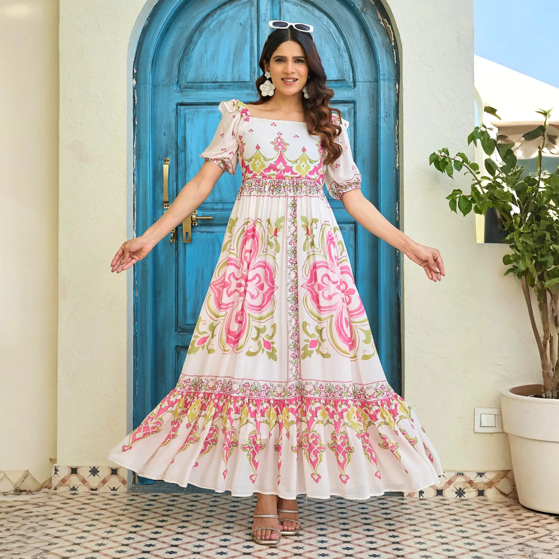 Women wearing maxi dress with colorful motif print twirling beautifully, highlighting its flared hem and lightweight fabric.