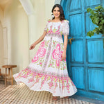 White and pink long maxi dress with square neckline captured in motion, showing breezy and comfortable style for daytime wear.