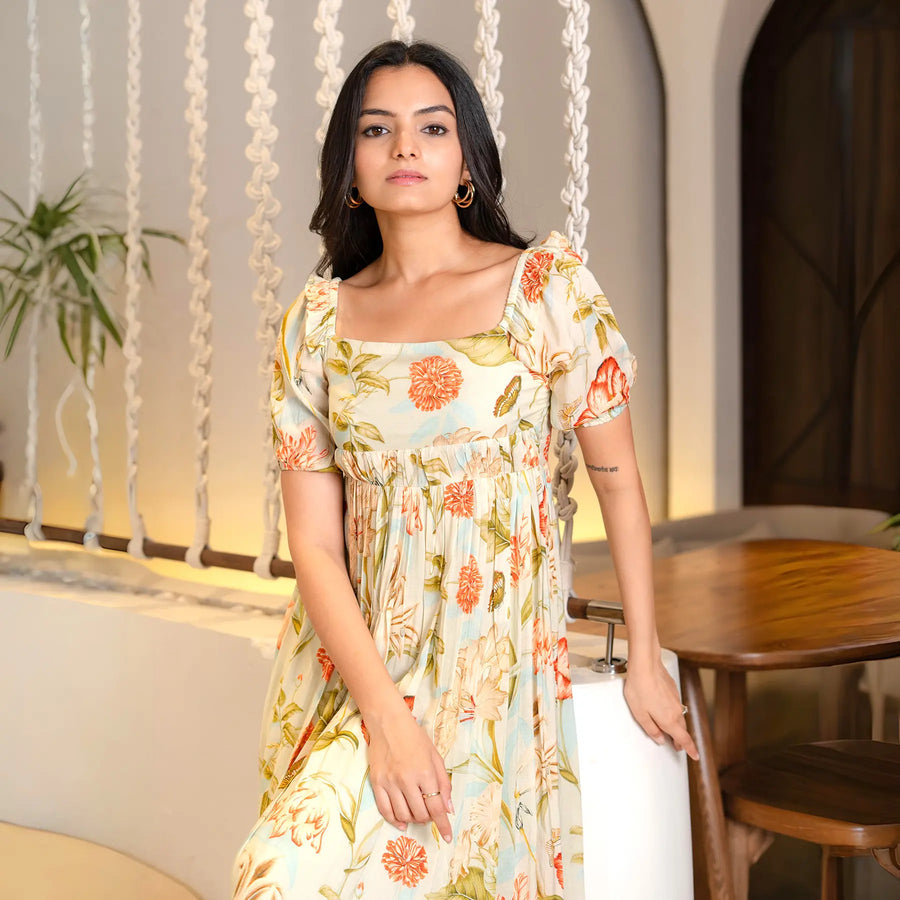 Seated close-up showing neckline and puff sleeves of a floral maxi one piece, perfect for elegant occasions.