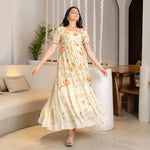 Twirl pose in a floral A-line maxi dress, a playful style suited for birthdays and summer gatherings.