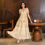 Walking pose in a breezy floral maxi dress for women, designed for brunches and festive events.