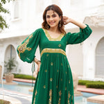Close-up of model wearing a green long maxi dress with detailed golden prints, suited for weddings and festive occasions.
