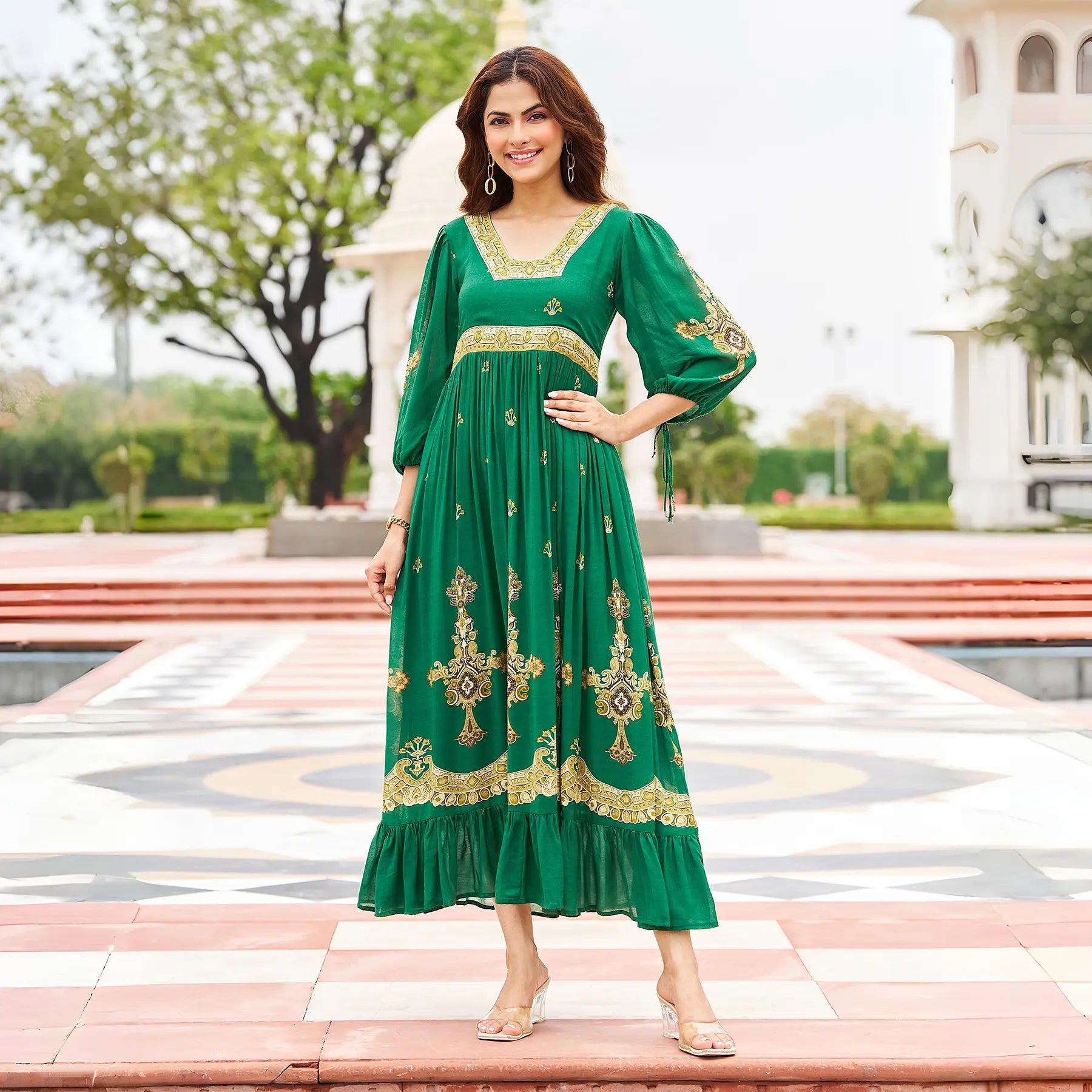 Model in a green maxi dress for women with golden ethnic print, perfect for Diwali and festive gatherings.
