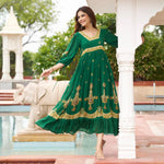 Movement shot in a green a line long dress with intricate motifs, perfect for cultural gatherings and festive dinners.