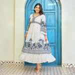 Flowing floral maxi dress with navy border print twirling beautifully, showing its flared hem and lightweight drape, ideal for brunch or birthday outings.