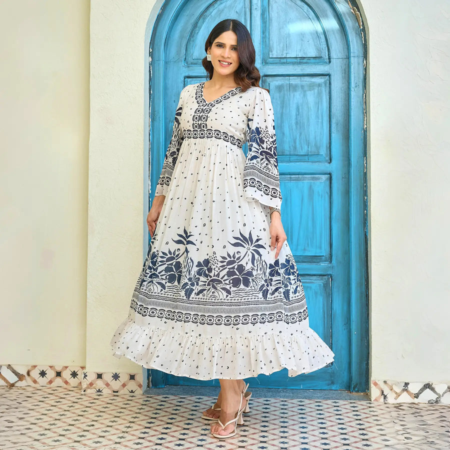 Flowing floral maxi dress with navy border print twirling beautifully, showing its flared hem and lightweight drape, ideal for brunch or birthday outings.