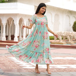 Model twirling in Mint Bloom aqua floral maxi dress with tiered hem, a flowy one piece dress perfect for beach vacations.