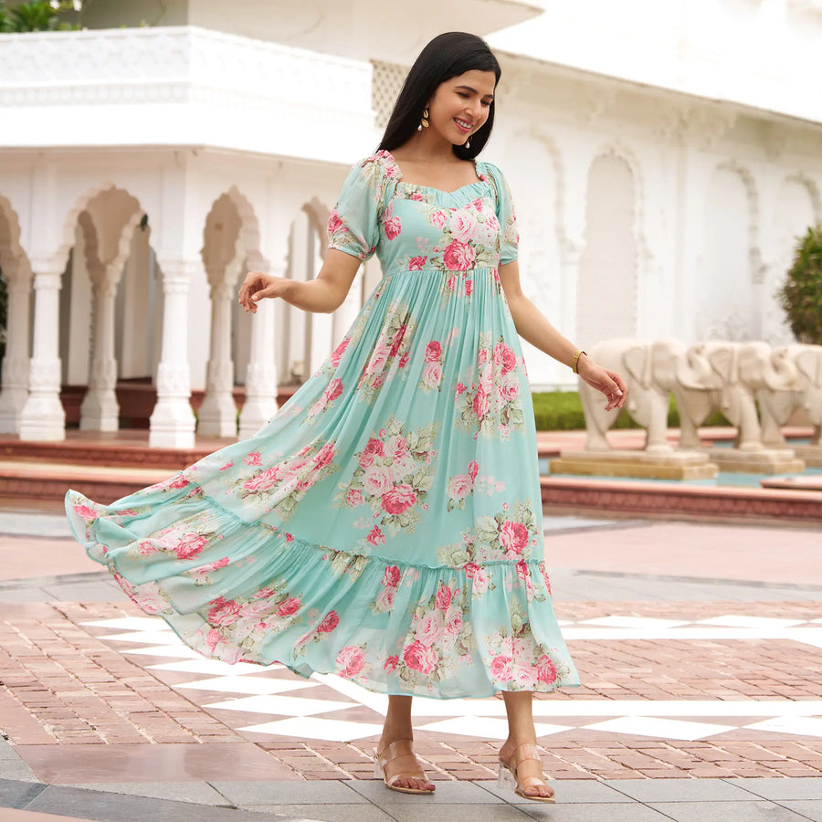 Model twirling in Mint Bloom aqua floral maxi dress with tiered hem, a flowy one piece dress perfect for beach vacations.