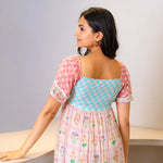 Back view showing the puff sleeve  and elegant maxi style, ideal for vacations and outdoor gatherings.