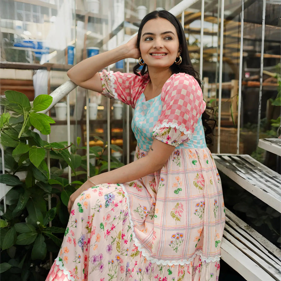 Candid sitting pose in a flowy floral maxi, designed for getaways and celebrations.