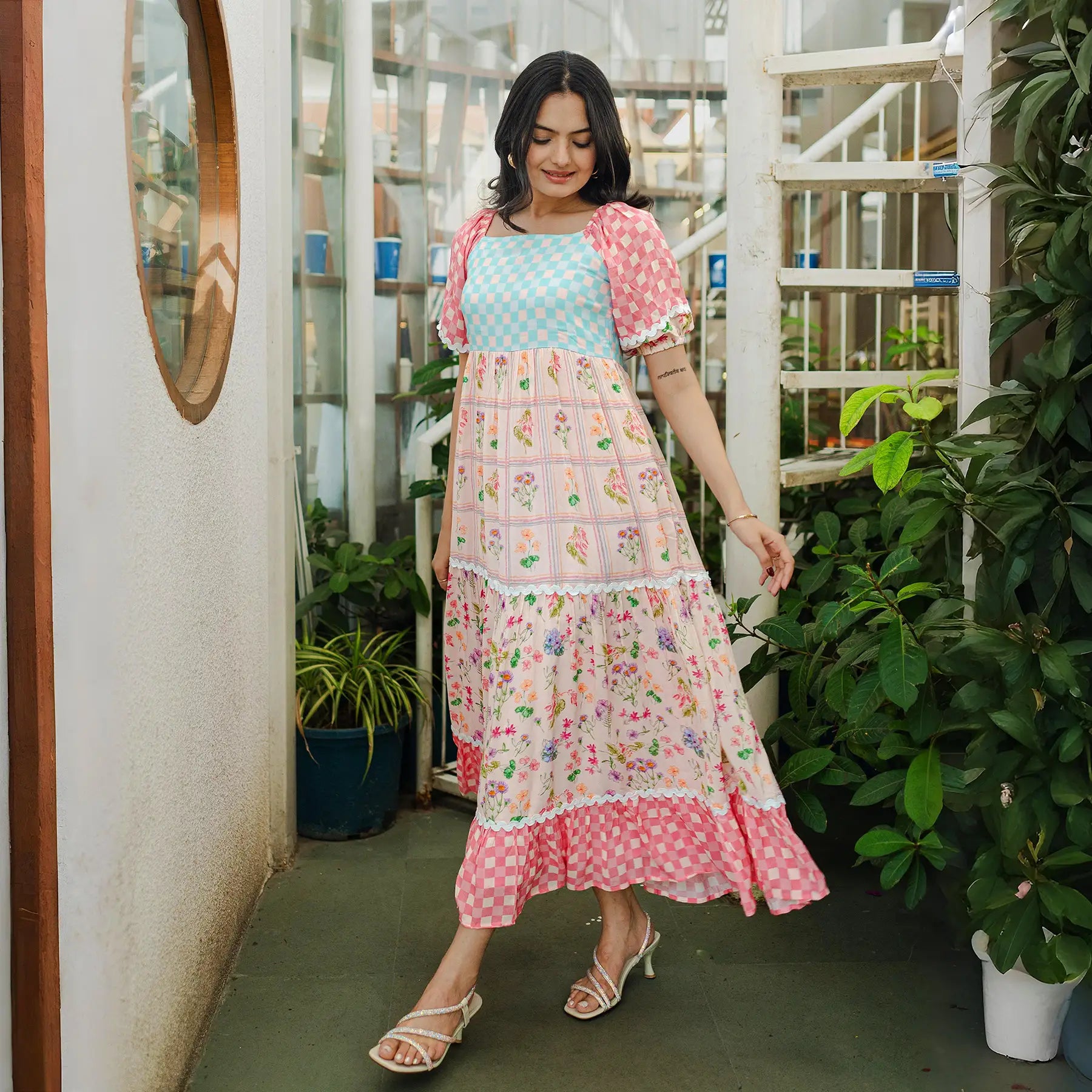 Mid-step flowy pose in a breezy floral maxi dress, perfect for festive evenings and summer days.