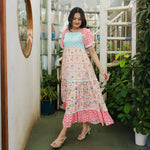 Mid-step flowy pose in a breezy floral maxi dress, perfect for festive evenings and summer days.