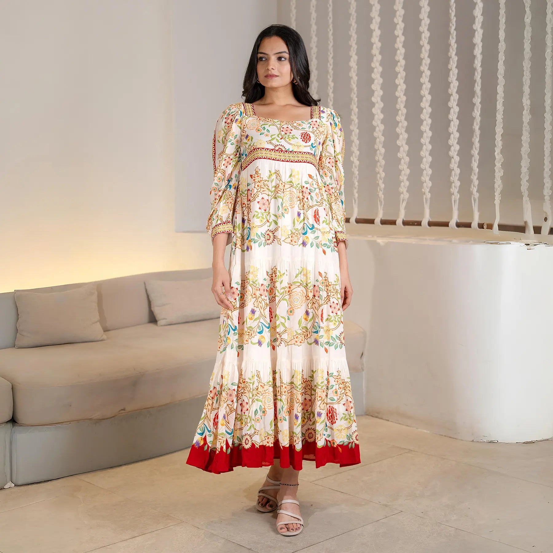Model standing front-facing in a long sleeve floral dress, styled for festive gatherings and vacations.
