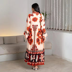 Back view highlighting the long flow and dramatic sleeves of a designer one-piece maxi dress.