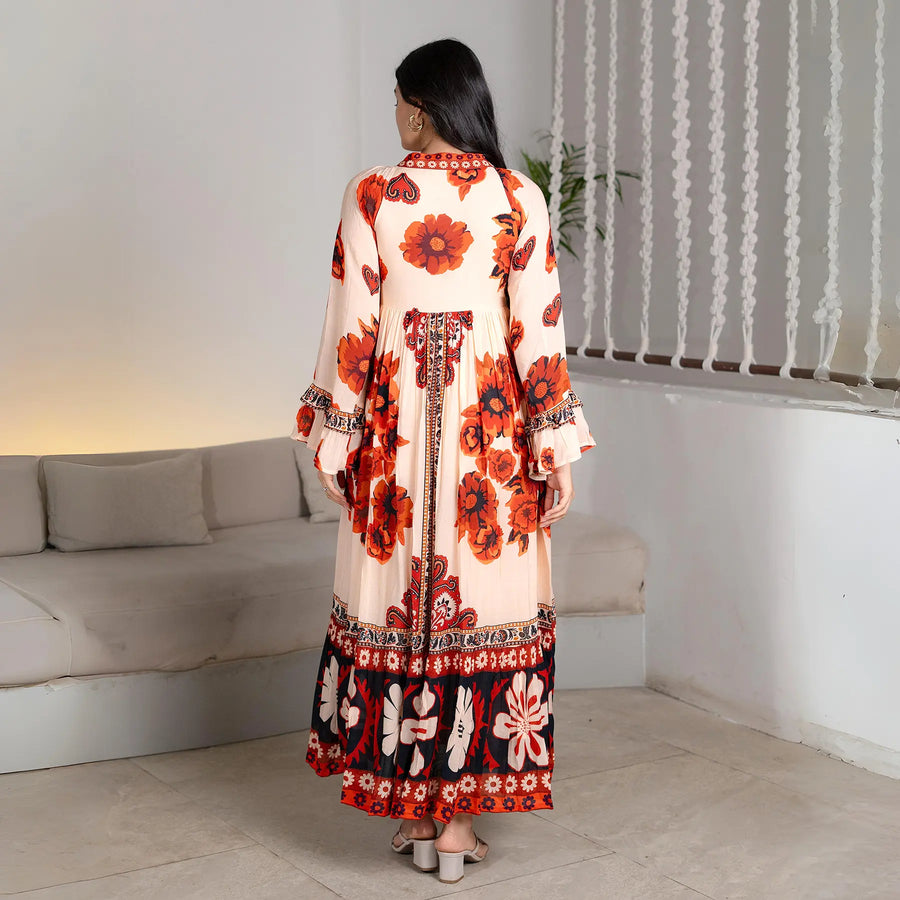 Back view highlighting the long flow and dramatic sleeves of a designer one-piece maxi dress.