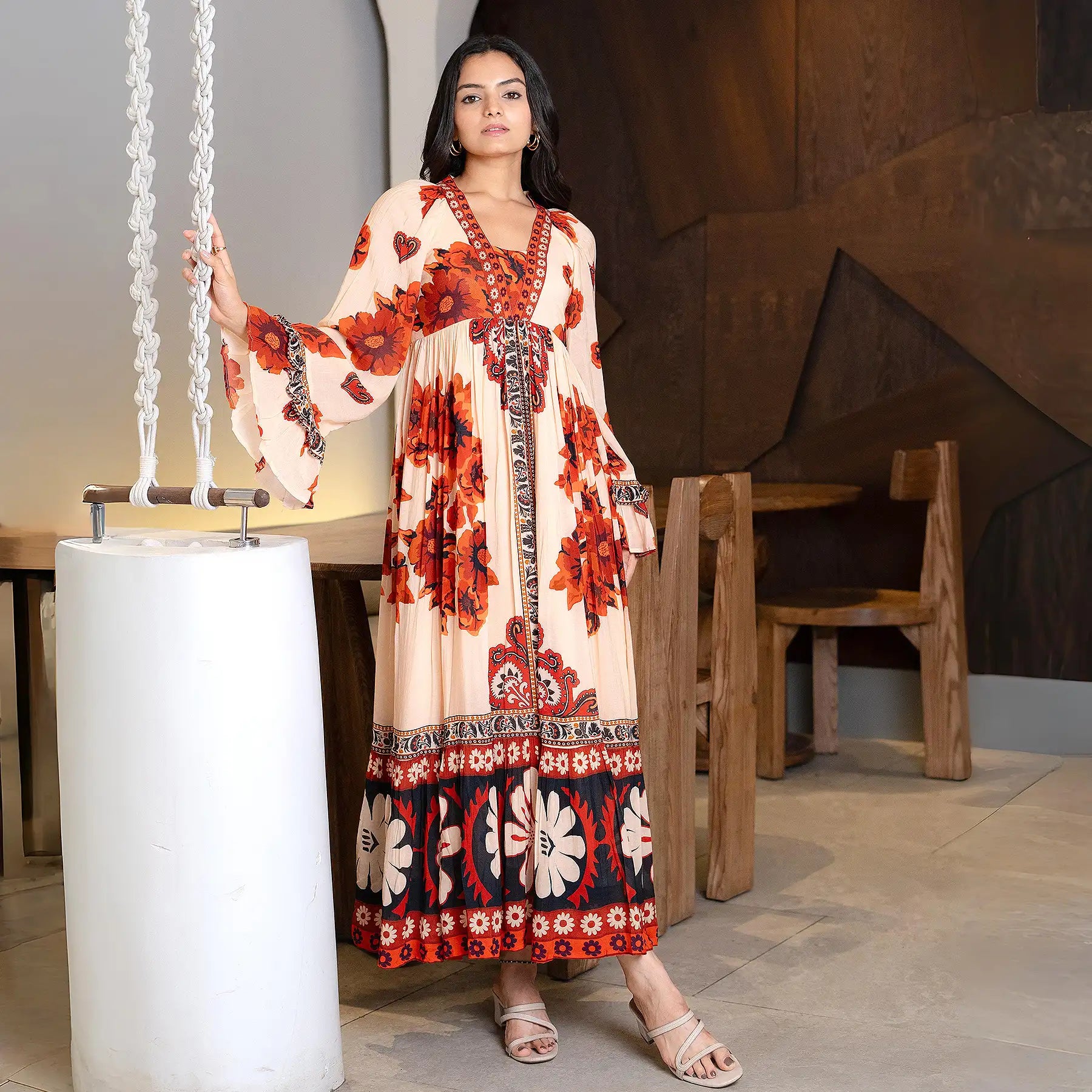 Front pose in the Saffron Valley designer floral maxi dress with bell sleeves, styled for festive gatherings.