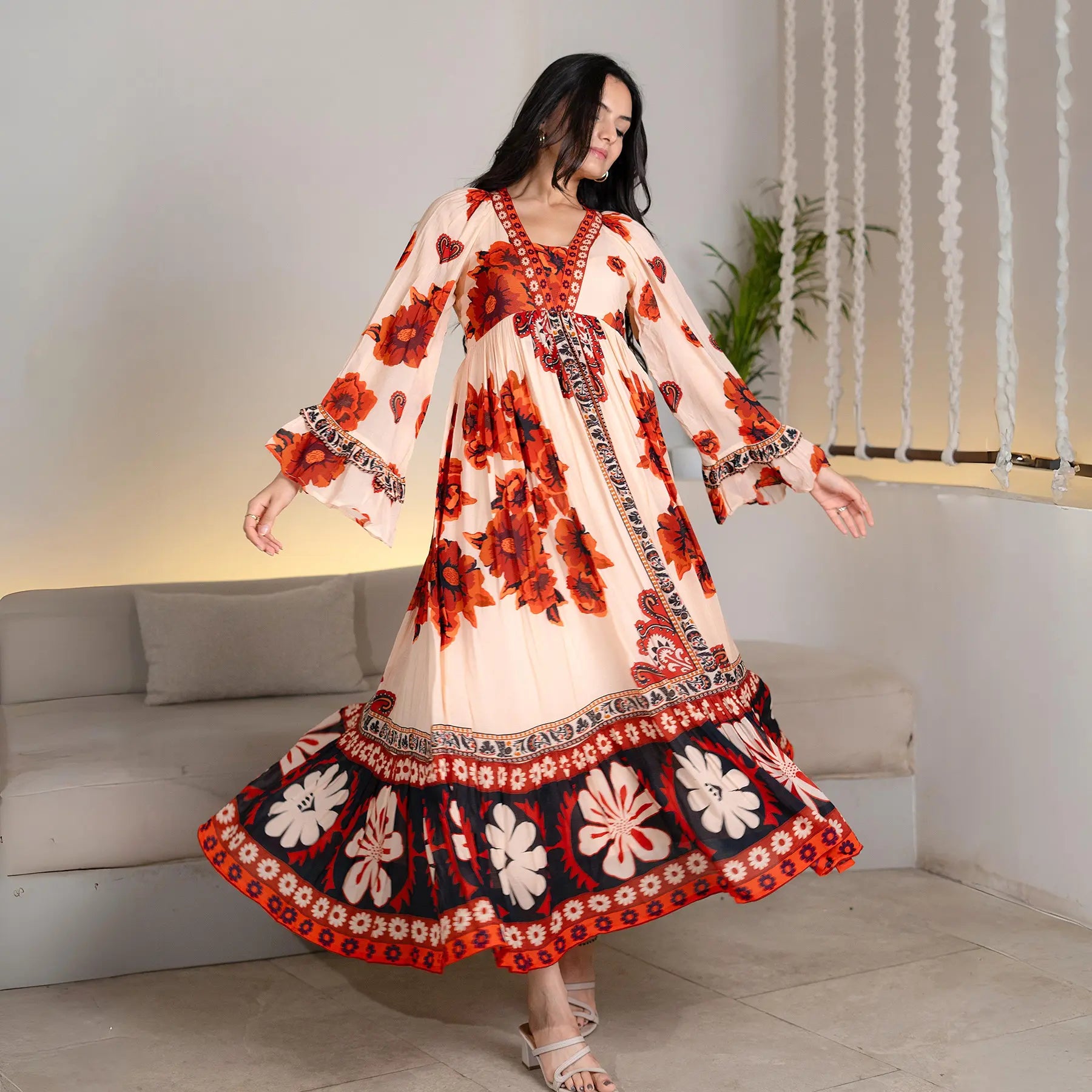 Twirling pose showing the flow of a floral designer maxi dress, perfect for birthdays and vacation evenings.