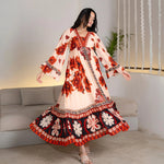 Twirling pose showing the flow of a floral designer maxi dress, perfect for birthdays and vacation evenings.