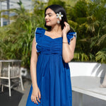 Close-up of a sleeveless maxi dress highlighting neckline and sleeve details.