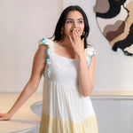 Close-up of an A-line maxi dress showing neckline and ruffle details, styled for summer.