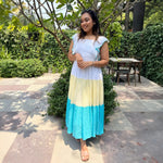 Summer maxi dress styled with natural accessories, perfect for resort and vacation wear.